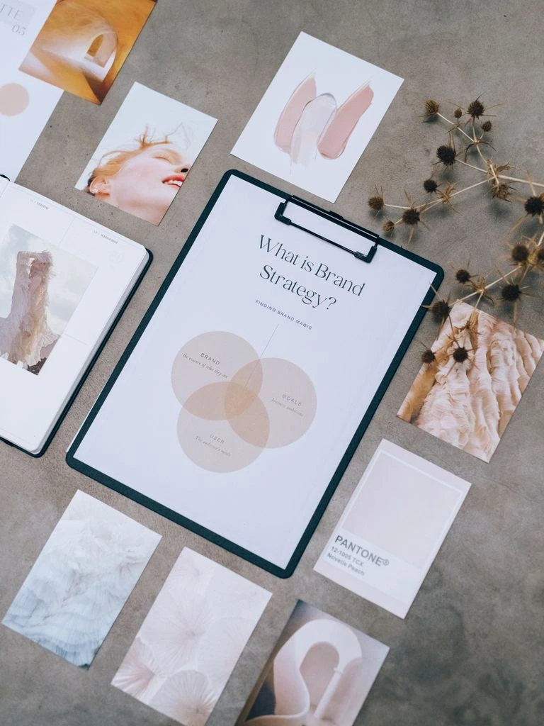 A flat lay of silk, gold, and linen on travertine.